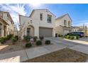 Two-story home featuring a two-car garage, a welcoming wreath on the front door, and lush landscaping at 10029 E Tahoe Ave, Mesa, AZ 85212