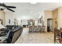 Open-concept living room with tile flooring, high ceilings, and seamless flow to kitchen at 10282 E Trailhead Ct, Gold Canyon, AZ 85118