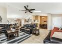 Spacious living room featuring tile floors, a ceiling fan, and seamless transition to dining area at 10282 E Trailhead Ct, Gold Canyon, AZ 85118