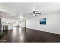 Bright living room with dark hardwood floors and open floor plan at 10572 W Echo Ln, Peoria, AZ 85345