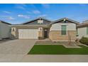 Modern house with a landscaped front yard and a white garage door at 11444 N Northfield St, Surprise, AZ 85388