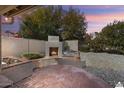 Inviting backyard with a brick fireplace and seating area at 15406 W Pinchot Ct, Goodyear, AZ 85395