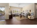 Living room featuring comfortable seating and wood-look floors at 16203 W Starry Sky Dr, Surprise, AZ 85374