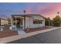 Well-maintained manufactured home with covered porch and mature landscaping at 205 S Higley Rd # 189, Mesa, AZ 85206