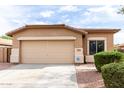 Inviting single-level home with a neutral color palette, a spacious driveway, and a neatly manicured front yard at 2077 W Tanner Ranch Rd, San Tan Valley, AZ 85144