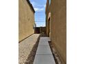 Side yard with gravel, concrete walkway, and a gate at 23889 N Mirage Ave, Florence, AZ 85132