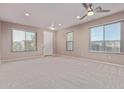 Bright and airy living room with neutral carpeting and large windows at 32211 N Lepa Dr, San Tan Valley, AZ 85144