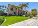 Two-story house with palm trees, a three-car garage, and a well-manicured lawn at 3503 E Princeton Ct, Gilbert, AZ 85234