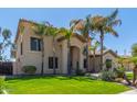 Two-story house with palm trees, a three-car garage, and a well-manicured lawn at 3503 E Princeton Ct, Gilbert, AZ 85234
