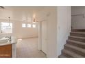 Kitchen with island and view into living room at 402 N 66Th Ln, Phoenix, AZ 85043