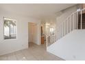 Bright living room with tiled floors and stairs at 402 N 66Th Ln, Phoenix, AZ 85043