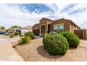 Inviting home featuring a desert landscape with mature shrubs and a two car garage at 41917 W Manderas Ln, Maricopa, AZ 85138