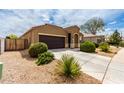 Beautiful single-story home boasting a tidy front yard, a long driveway, and an attached two-car garage at 41917 W Manderas Ln, Maricopa, AZ 85138