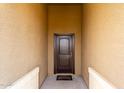 A close up of a front door that is framed by an exterior wall at 41917 W Manderas Ln, Maricopa, AZ 85138