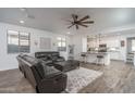 Open living room with hardwood floors and a view of the kitchen at 44968 W Norris Rd, Maricopa, AZ 85139