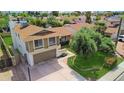 Two-story home features a large driveway, an attached garage, manicured lawn, and desert landscaping at 4615 W Boston St, Chandler, AZ 85226