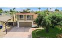 Two-story home featuring an attached garage, well-maintained lawn, and mature tree in a quiet neighborhood at 4615 W Boston St, Chandler, AZ 85226