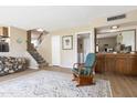 Living room with neutral walls, vinyl floors, rocking chair, and staircase at 4615 W Boston St, Chandler, AZ 85226