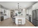 Elegant kitchen with white cabinetry, large island, and wine storage at 6607 E Libby St, Phoenix, AZ 85054