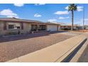 House on a tree-lined street with a gravel driveway at 7861 E Natal Ave, Mesa, AZ 85209