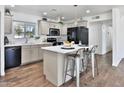 Updated kitchen with stainless steel appliances, a center island, and wood-look flooring for a modern look at 811 W Northern Ave, Phoenix, AZ 85021