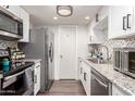 Modern kitchen with stainless steel appliances and granite countertops at 954 E Diamond Dr, Tempe, AZ 85283