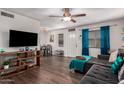 Living room with sectional sofa, wood floors, and a large TV at 954 E Diamond Dr, Tempe, AZ 85283
