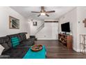 Spacious living room with sectional sofa, wood floors, and staircase at 954 E Diamond Dr, Tempe, AZ 85283
