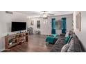 Living room features a sectional sofa, media console, and wood-look floors at 954 E Diamond Dr, Tempe, AZ 85283