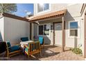 Small patio with seating area located at the townhome's entrance at 954 E Diamond Dr, Tempe, AZ 85283