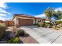 Tan single-story home with a tile roof, desert landscaping and a wide driveway at 1081 W Brangus Way, San Tan Valley, AZ 85143