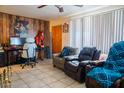 Living room with wood paneled wall and comfy seating at 11217 W Missouri Ave, Youngtown, AZ 85363