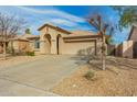 Well-maintained single-story home with desert landscaping and a two-car garage at 11810 W Belmont Dr, Avondale, AZ 85323