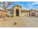 Charming single-story home featuring a desert landscaped front yard and covered entryway at 11810 W Belmont Dr, Avondale, AZ 85323