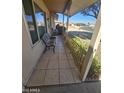 Inviting front porch with tiled flooring and a bench at 12226 N Lakeforest Dr, Sun City, AZ 85351