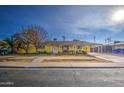 Bright yellow single-story home with a well-maintained lawn at 1555 W 7Th Pl, Mesa, AZ 85201