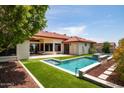 Stunning backyard oasis featuring a refreshing pool and lush landscaping at 15613 E Palomino Blvd, Fountain Hills, AZ 85268