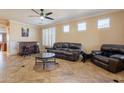 Spacious living room with leather furniture, a coffee table, and a home bar at 17581 W Canyon Ln, Goodyear, AZ 85338