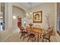 Cozy dining room featuring a wooden table with seating for six, a chandelier, and elegant decor at 17906 N Encanto Dr, Surprise, AZ 85374