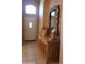 Entryway with tiled floor, console table, and ornate mirror at 17906 N Encanto Dr, Surprise, AZ 85374