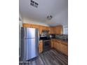 Updated kitchen features stainless steel appliances and wood cabinets at 2118 E Oak St, Phoenix, AZ 85006