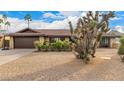 Charming single-story home with desert landscaping and a two-car garage at 2401 E Christy Dr, Phoenix, AZ 85028