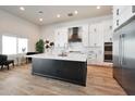 Spacious kitchen featuring a large island, modern appliances, and white cabinetry at 25232 S Pyrenees Ct, Queen Creek, AZ 85142