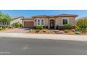 Single story home with desert landscaping and a two-car garage at 26647 W Covey Ln, Buckeye, AZ 85396