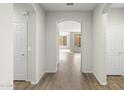 Bright entryway with hardwood floors and archways leading to other rooms at 26861 W Adam Ave, Buckeye, AZ 85396