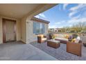 Covered patio with wicker furniture and a view of the backyard at 26861 W Adam Ave, Buckeye, AZ 85396