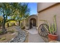 Charming entryway with a stone path and wooden gate at 3071 Ironwood Rd, Carefree, AZ 85377