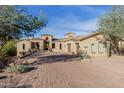 Expansive, single-story home featuring a brick driveway and desert landscaping at 3254 N Ladera Cir, Mesa, AZ 85207