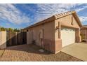 Exterior view of the two-car garage and side gate at 3404 E Los Altos Rd, Gilbert, AZ 85297