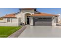 House exterior showcasing a two-car garage and well-maintained lawn at 3450 N 67Th Dr, Phoenix, AZ 85033